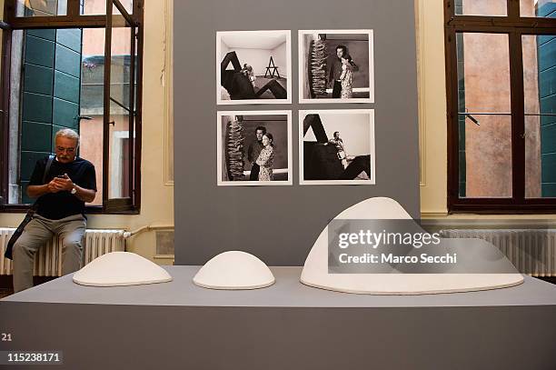 Man use his mobile phone next to "Scogliera" by Pino Pascali part of the Piero Pascali exhibition on June 3, 2011 in Venice, Italy. The Venice Art...