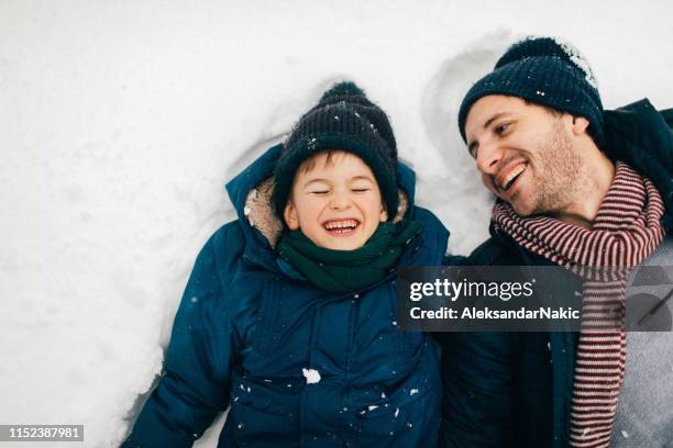 fun on the snow - family winter stock pictures, royalty-free photos & images