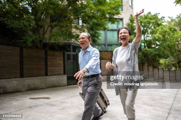 grandparents arriving at children's front yard - female waving on street stock pictures, royalty-free photos & images