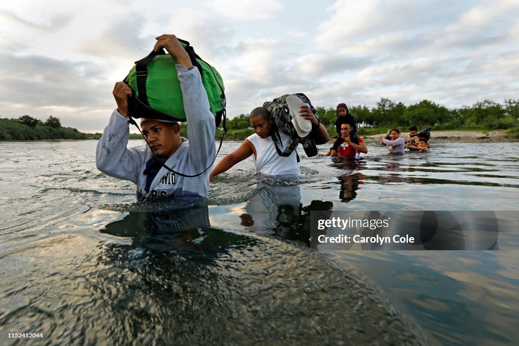 Migrants Cross The Rio Grande