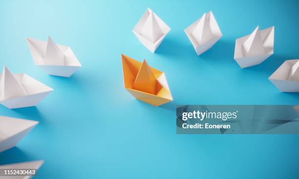 leadership concept with paper boats - origami boat stock pictures, royalty-free photos & images