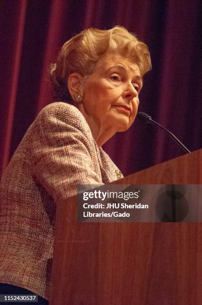 Low angle, three quarter profile shot of Phyllis Schlafly , standing behind a podium while speaking during a Milton S Eisenhower Symposium, Homewood...