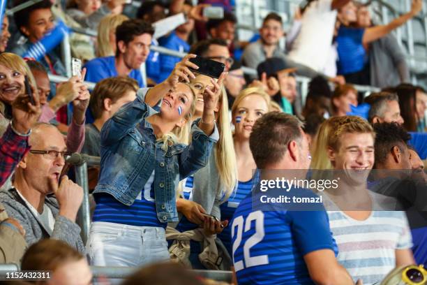 female friends at footbal match making a selfie - hockey crowd stock pictures, royalty-free photos & images