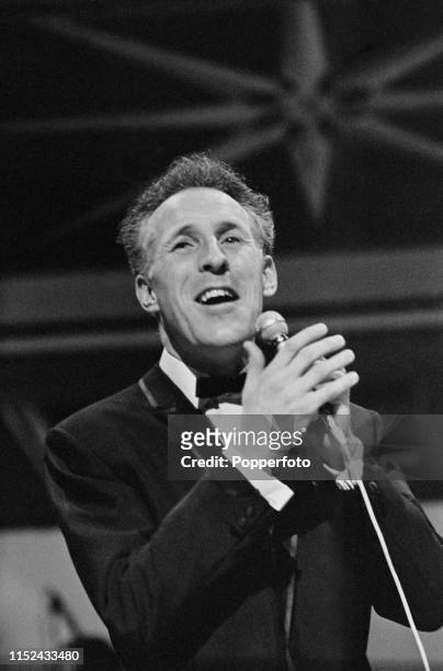 English comedian, singer and entertainer Bruce Forsyth performs live on stage at the Palladium theatre in London in September 1964.