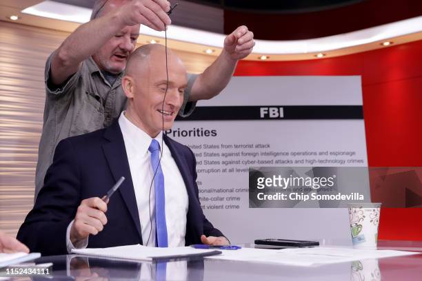 Global Natural Gas Ventures founder Carter Page has a microphone attached to his lapel before participating in a discussion on 'politicization of DOJ...