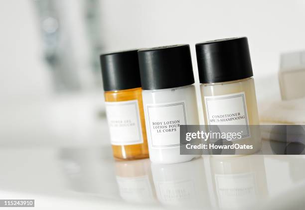 shampoo, conditioner and soap bottles - hotel bathroom stock pictures, royalty-free photos & images