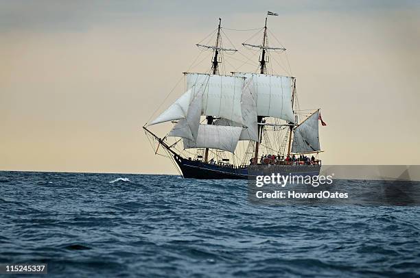 tall ship sailing into sunset, cornwall - uk - tall ship stock pictures, royalty-free photos & images