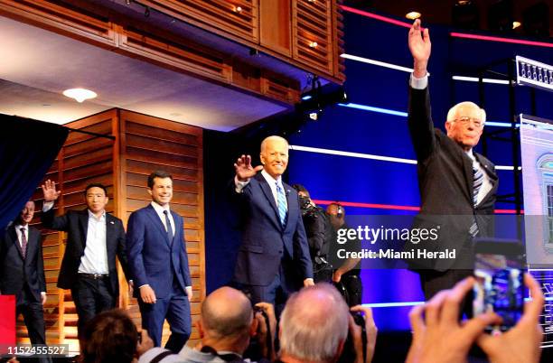 Democratic presidential candidates wave to the crowd as they arrive to the stage at the Adrienne Arsht Center for the Performing Arts in Miami on...