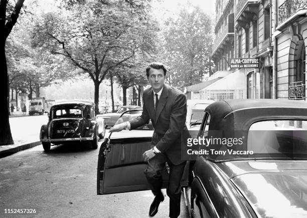 Designer Hubert De Givenchy is stepping out of the Mercedes car in front of his Paris Showroom. He is out of the car running very elegantly looking...