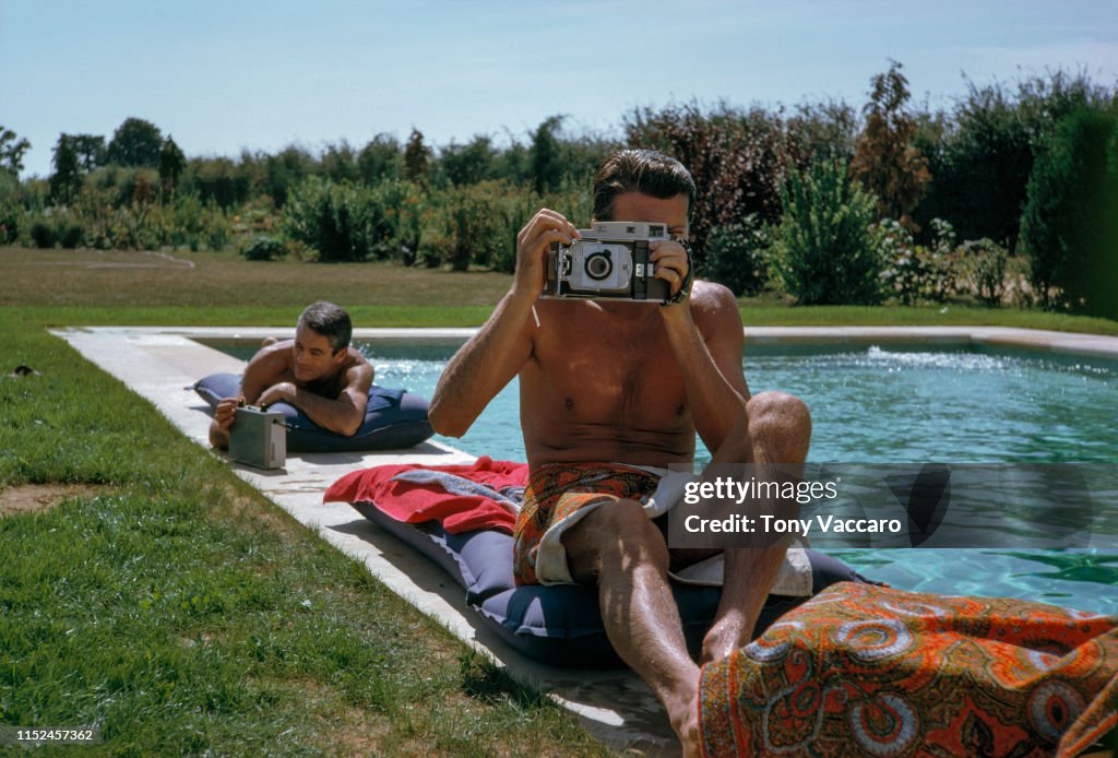 Hubert De Givenchy is sitting by the pool with Philippe Venet at