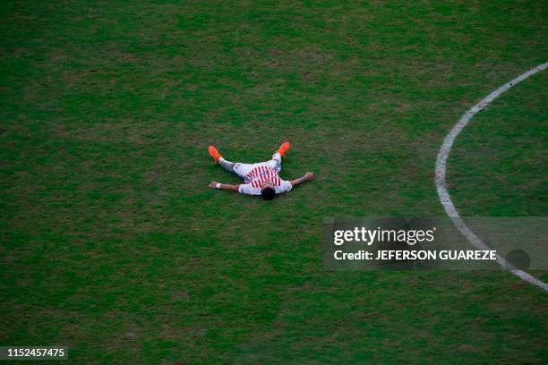 Paraguay's Derlis Gonzalez gestures on the ground after a foul by Brazil's Arthur during their Copa America football tournament quarter-final match...