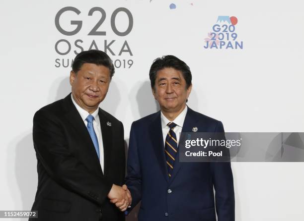 Chinese President Xi Jinping welcomed by Japanese Prime Minister Shinzo Abe for a family photo session on the first day of the G20 summit on June 28,...