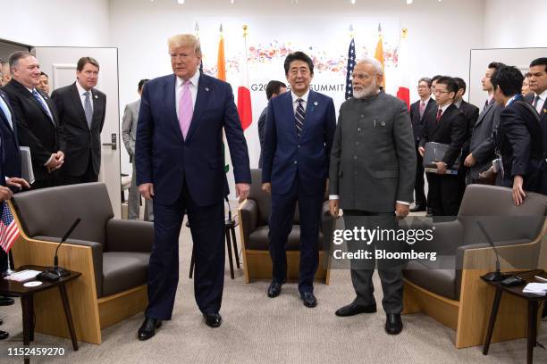 President Donald Trump, left, Shinzo Abe, Japan's prime minister, center, and Narendra Modi, India's prime minister, right, attend a trilateral...