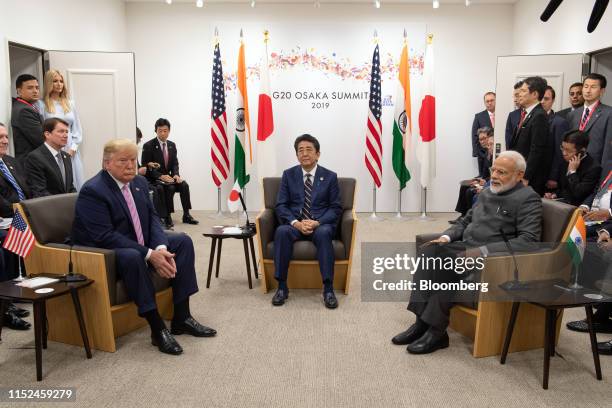 President Donald Trump, left, Shinzo Abe, Japan's prime minister, center, and Narendra Modi, India's prime minister, attend a trilateral meeting at...