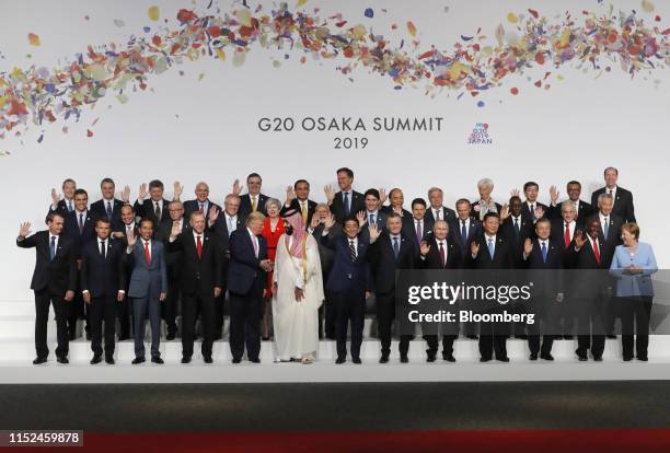 President Donald Trump, front row fifth left, speaks with Mohammed Bin Salman, Saudi Arabia's crown prince, front row sixth left, as Jair Bolsonaro,...