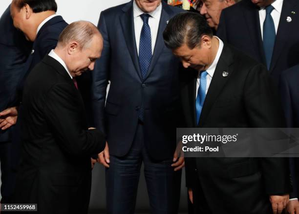 Russian President Vladimir Putin and Chinese President Xi Jinping before a family photo session at G20 summit on June 28, 2019 in Osaka, Japan. U.S....