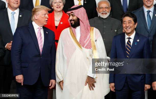President Donald Trump speaks with Saudi Arabia's Crown Prince Mohammed bin Salman during a family photo session at G20 summit on June 28, 2019 in...