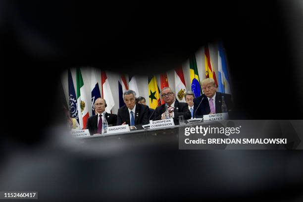 Russia's President Vladimir Putin, Singapore's Prime Minister Lee Hsien Loong, President of the European Commission Jean-Claude Juncker and US...