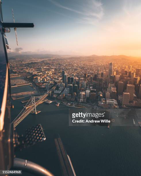 looking back on downtown san francisco from a helicopter during sunset - san francisco california aerial stock pictures, royalty-free photos & images