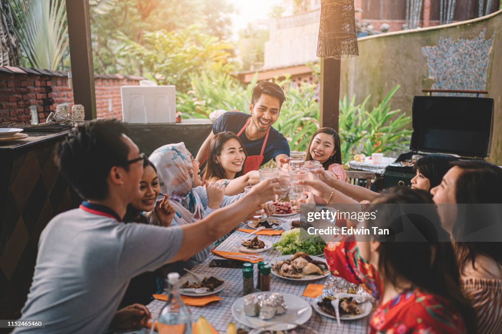 A group ph multi ethic friends having a celebration toast at the dinning area at villa during weekend city break