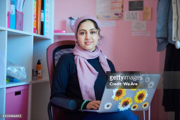 portrait of young muslim woman studying in bedroom - hijab student stock pictures, royalty-free photos & images