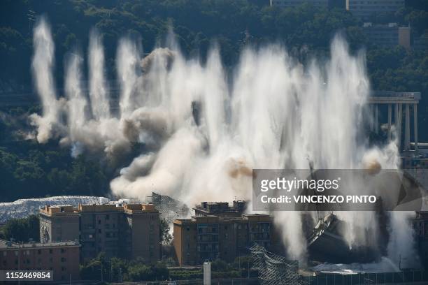 Explosive charges blow up the eastern pylons of Genoa's Morandi motorway bridge on June 28, 2019 in Genoa. - Some of the remains of Genoa's Morandi...