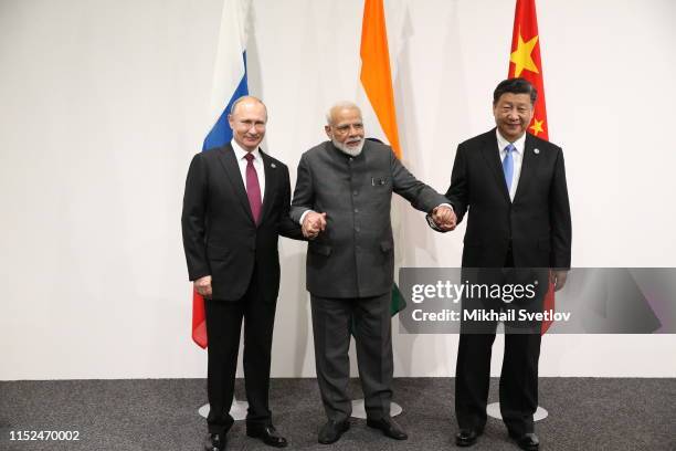 Russian President Vladimir Putin , Indian Prime Minister Narendra Modi and Chinese President Xi Jinping pose for a group photo prior to their...