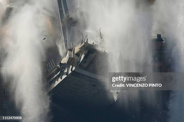 Explosive charges blow up the eastern pylons of Genoa's Morandi motorway bridge on June 28, 2019 in Genoa. - Some of the remains of Genoa's Morandi...