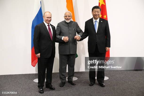Russian President Vladimir Putin , Indian Prime Minister Narendra Modi and Chinese President Xi Jinping pose for a group photo prior to their...
