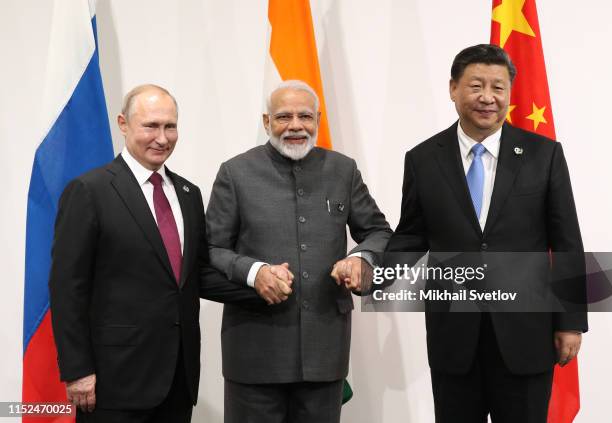 Russian President Vladimir Putin , Indian Prime Minister Narendra Modi and Chinese President Xi Jinping pose for a group photo prior to their...