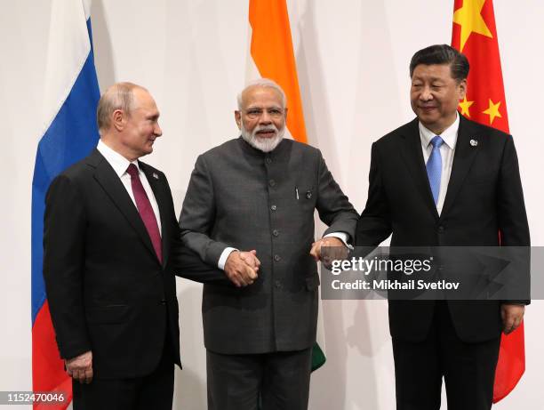 Russian President Vladimir Putin , Indian Prime Minister Narendra Modi and Chinese President Xi Jinping pose for a group photo prior to their...