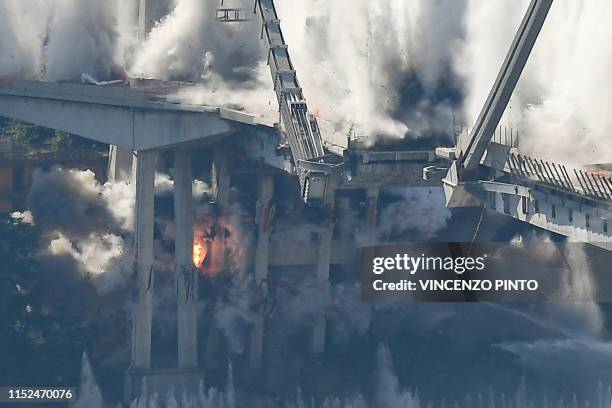 Explosive charges blow up the eastern pylons of Genoa's Morandi motorway bridge on June 28, 2019 in Genoa. - Some of the remains of Genoa's Morandi...