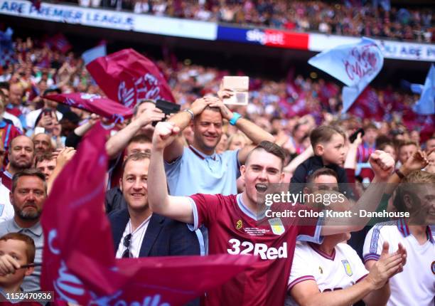 Aston Villa fans celebrate after winning the Sky Bet Championship Play-off Final match between Aston Villa and Derby County at Wembley Stadium on May...