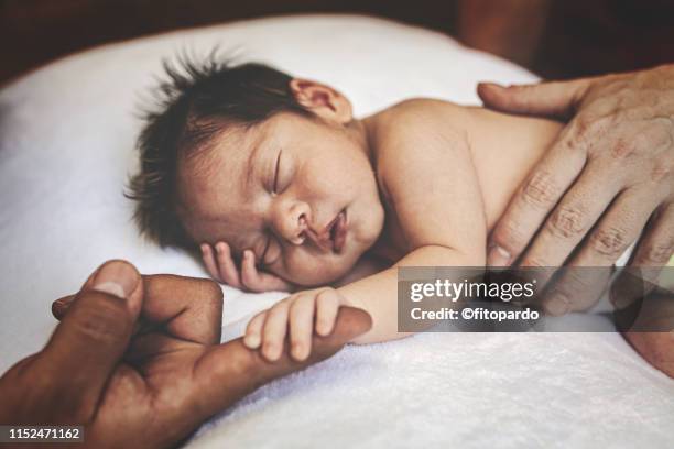 mixed race family together - baby close up bed stockfoto's en -beelden