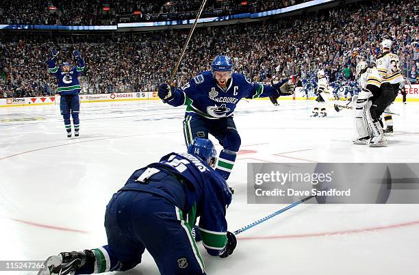 Henrik Sedin of the Vancouver Canucks celebrates the overtime goal by teammate Alex Burrows to win game two of the 2011 NHL Stanley Cup Finals...