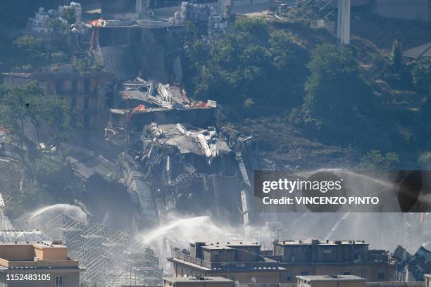 The bridge's deck lies in debris and rubble after explosive charges blew up the eastern pylons of Genoa's Morandi motorway bridge on June 28, 2019 in...