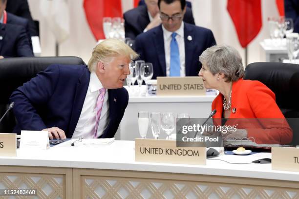 President Donald Trump , speaks to Theresa May, U.K. Prime minister, prior to a working lunch on the first day of the G20 summit on June 28, 2019 in...