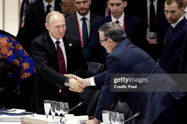 Vladimir Putin, Russia's president, left, shakes hands with Marcelo Ebrard, Mexico's secretary of foreign affairs, prior to a working lunch on the...