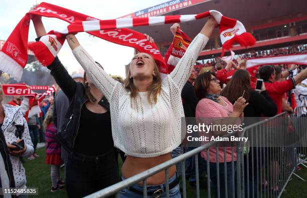Union Berlin fans celebrate at their team's stadium, the Alte Försterei, in the Berlin district of Köpenick after the promotion of the team to the...