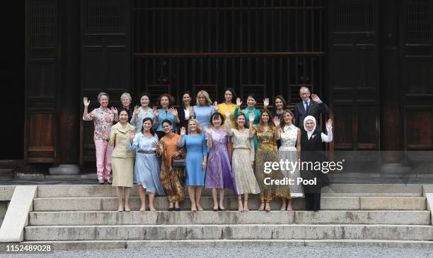 Partners of the G20 leaders pose for a family photo at G20 partners program in Tofuku-ji Temple on the first day of the G20 summit on June 28, 2019...