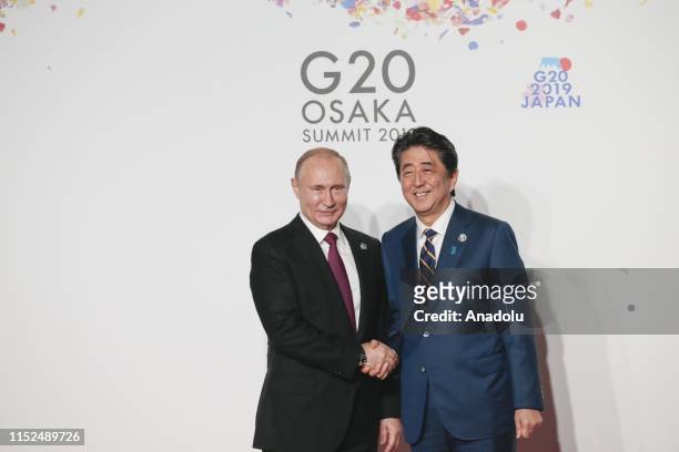 Russian President Vladimir Putin is welcomed by Japanese Prime Minister Shinzo Abe on the first day of the G20 summit in Osaka, Japan on June 28,...