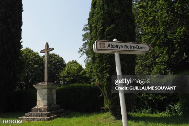 This picture taken on June 28, 2019 shows a sign indicating the entrance of the Notre Dame Abbey of Fontgombault, central France, where French...