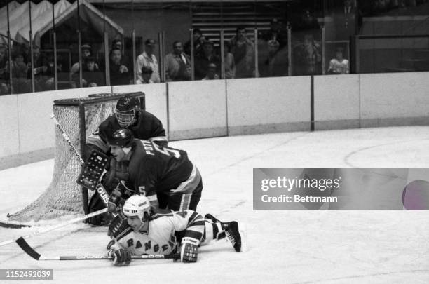 Islanders' Denis Potvin assists goalie Roland Melanson in save against Rangers' Mark Pavelich during 1st period action of NY Rangers v. NY Islanders...
