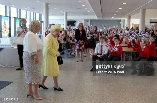 Queen Elizabeth II with headteacher Linda Park during a visit to Greenfaulds High School on June 28, 2019 in Cumbernauld, Scotland.