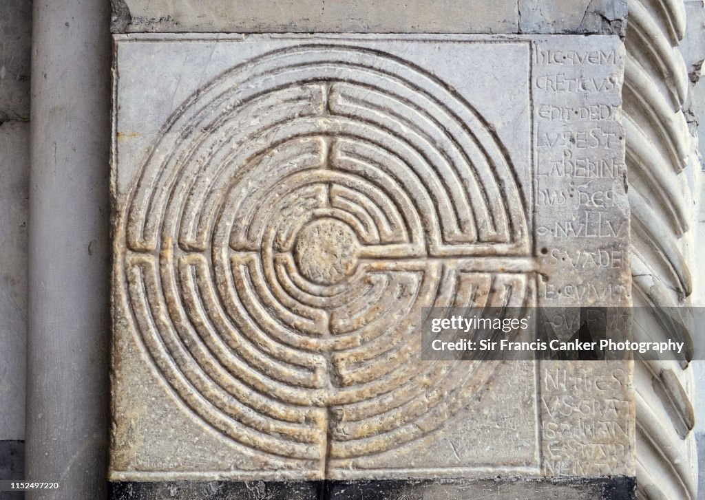 Labyrinth carved into stone on the walls outside of Lucca's cathedral in Tuscany, Italy