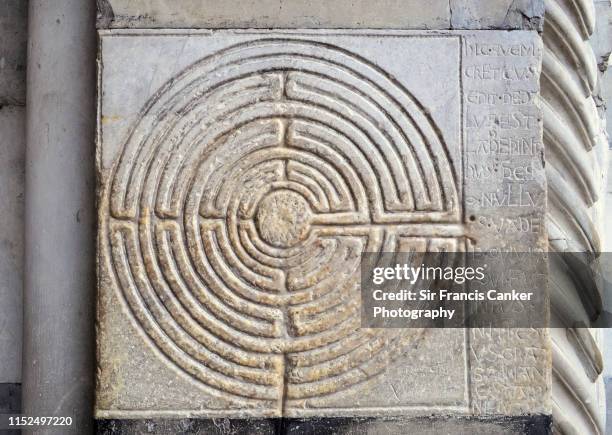 labyrinth carved into stone on the walls outside of lucca's cathedral in tuscany, italy - lucca foto e immagini stock