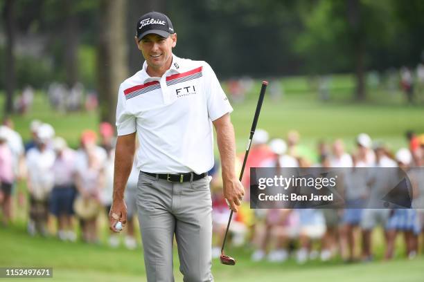 Charles Howell III smiles after making a putt on the sixth green during the first round of the Rocket Mortgage Classic at Detroit Golf Club on June...