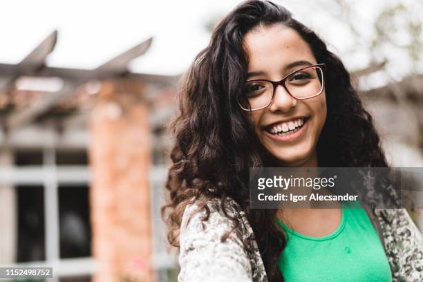 smiling teen girl looking at camera - cute 15 year old girls stock pictures, royalty-free photos & images