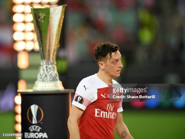 Mesut Ozil of Arsenal removes his runners up medal following his team's defeat in the UEFA Europa League Final between Chelsea and Arsenal at Baku...