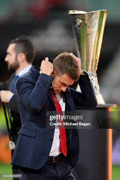 Aaron Ramsey of Arsenal removes his runners up medal following his team's defeat in the UEFA Europa League Final between Chelsea and Arsenal at Baku...